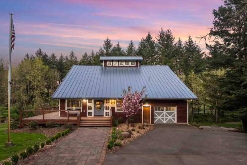 a small house with a gambrel roof with a porch at Swallows Nest in Salem