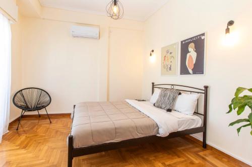 a bedroom with a bed and a chair at Lucas apartment 1 in Athens