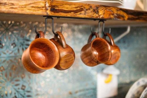 a group of wooden utensils hanging on a shelf at Hobbits Rest in Salem