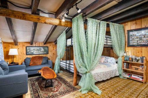 a bedroom with a bed and a couch in a room at Hobbits Rest in Salem