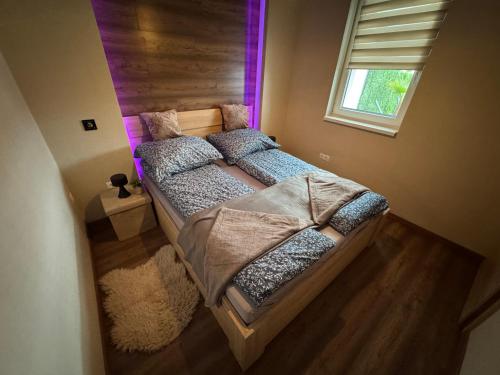 a large bed in a room with a window at Penthouse Happy Seasons in Hajdúszoboszló