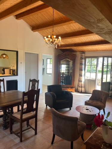 un salon avec une table et des chaises dans l'établissement Maison L union, à Beauvoir-sur-Mer