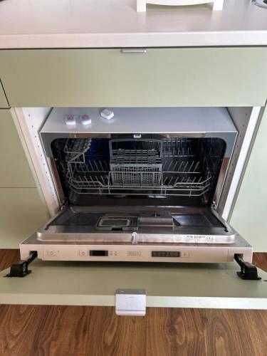 an oven with its door open in a kitchen at Cottage Gols in Gols
