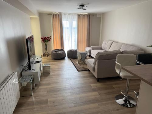 a living room with a couch and a tv at Seaview Flat Cobh in Cobh