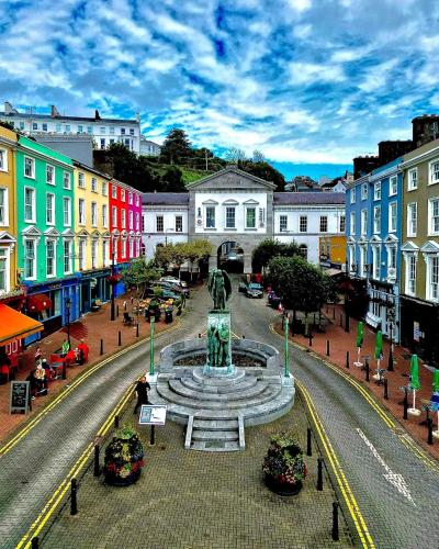 a city with a fountain in the middle of a street at Seaview Flat Cobh in Cobh