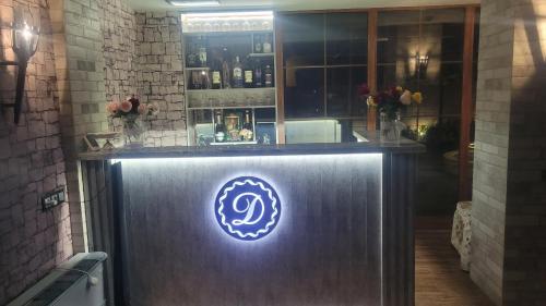 a bar with a blue neon sign on it at DALLAR Guest House in Yerevan