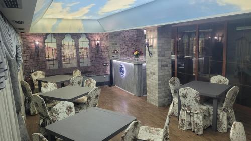 a restaurant with tables and chairs in a room at DALLAR Guest House in Yerevan