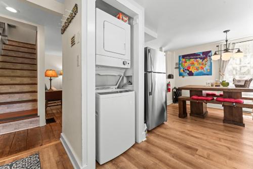 a kitchen with a refrigerator and a dining room at Charming Historic Schoolhouse on Mystic River in Groton