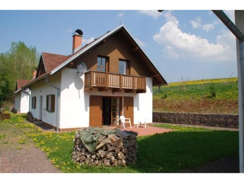 a small white house with a balcony on top at Holiday Home in Javorník near Giant Mountains in Rudník