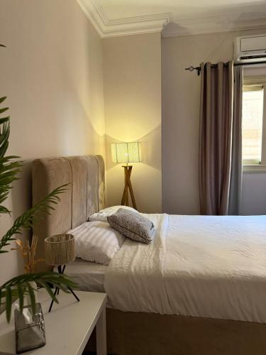a bedroom with a bed and a couch at فيلا مبهجة مع مسبح وحديقة رائعة in 6th Of October