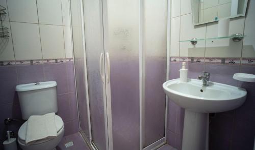 a bathroom with a toilet and a sink at HONEY SUİTEs 1 in Fethiye