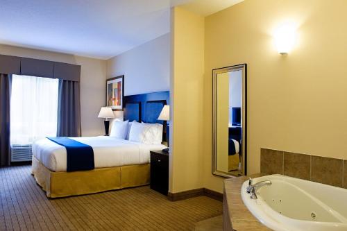 a hotel room with a bed and a bath tub at Holiday Inn Express & Suites-Regina-South by IHG in Regina