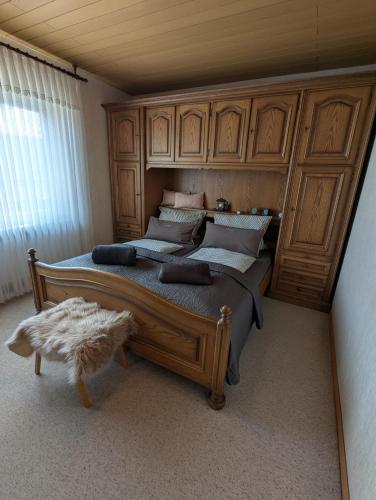 a bedroom with two beds with wooden cabinets at Ferienhaus Anni Rödental in Rödental