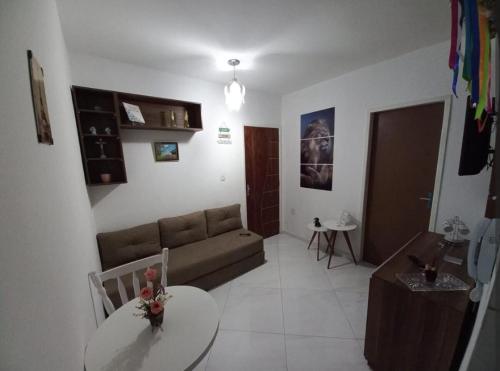 a living room with a couch and a table at kitnet encantador no centro de Campina Grande- PB - apt 102 in Campina Grande