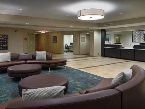 a large lobby with couches and chairs in a building at Candlewood Suites - Newark South - University Area by IHG in Newark