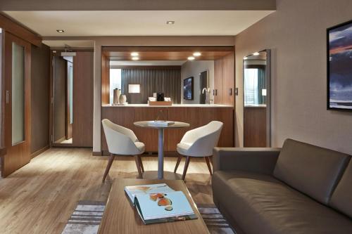 a living room with a couch and a table and chairs at AC Hotel Atlanta Downtown in Atlanta