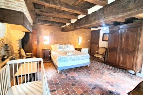 a bedroom with a bed in a room with wooden walls at La Bastide des Chézeaux - Brenne in Rivarennes