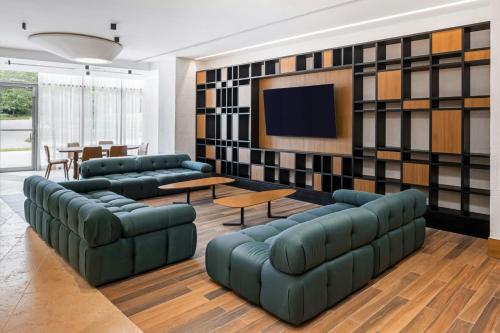 a living room with couches and a flat screen tv at Barranquilla Marriott Hotel in Barranquilla