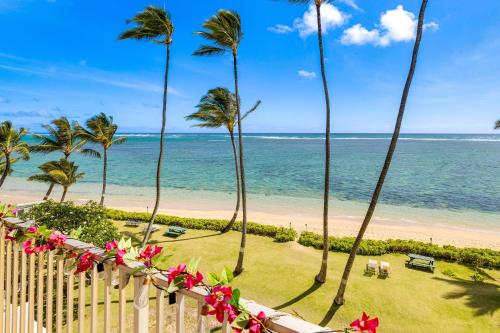 a view of the beach from the balcony of a resort at Oceanfront Condo Stunning Sunrise and Ocean Views in Hauula