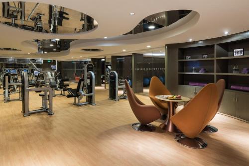 a salon with chairs and a table in a room at Pullman Nanjing Lukou Airport in Nanjing