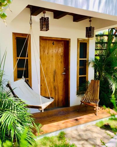 a porch with a hammock outside of a house at Casitas Pacific in Popoyo