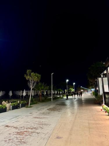 an empty street at night with a dark sky at Beach Apartments Durres in Durrës