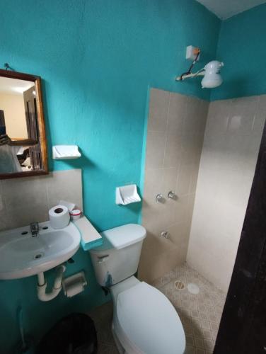 a bathroom with a white toilet and a sink at Las Villas Champoton in Champotón