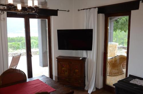a living room with a flat screen tv on a wall at Villa Panorama in Pridraga