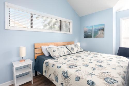 a bedroom with a bed and a window at ONE More Happy Day 3BR-3BA Beach House w-HotTub, Sleeps 11 in Myrtle Beach