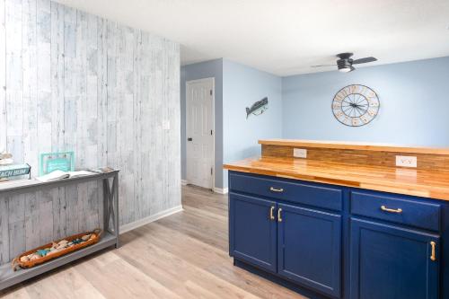 a kitchen with blue cabinets and blue walls at ONE More Happy Day 3BR-3BA Beach House w-HotTub, Sleeps 11 in Myrtle Beach
