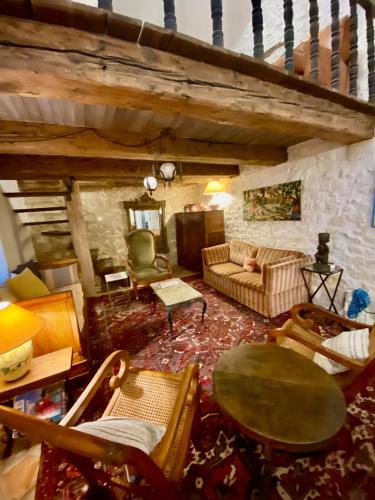 a living room with a couch and a table and chairs at La Mistraline, 2 bedrm 2 bath house in the heart of Provence in Caseneuve