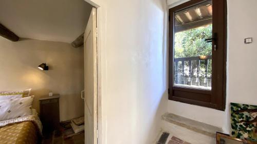 a room with a window and a bed in a room at La Mistraline, 2 bedrm 2 bath house in the heart of Provence in Caseneuve