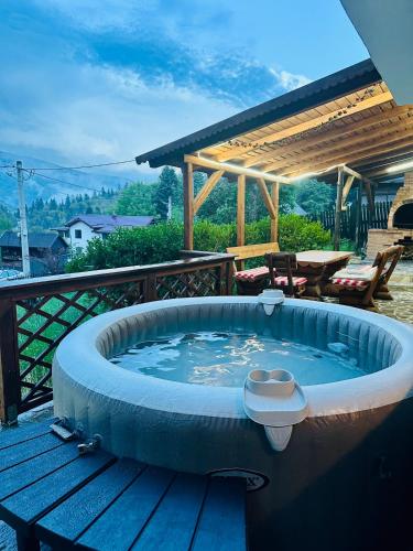 a hot tub on the deck of a house at Iepurasul Sinaia in Sinaia