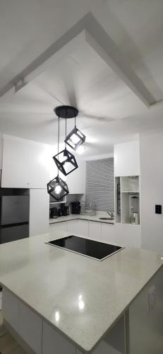 a kitchen with a white counter top with two lights at Sandhurst Luxury Accommodation Self-Catering Suites in Pietermaritzburg in Pietermaritzburg