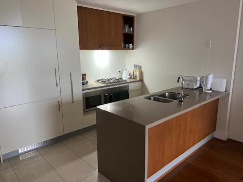 a kitchen with a sink and a counter top at Private room with river view in Brisbane