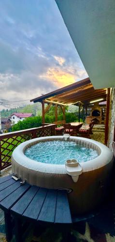 a hot tub sitting on top of a wooden deck at Iepurasul Sinaia in Sinaia