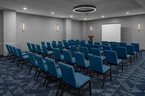 a conference room with blue chairs and a whiteboard at Courtyard San Jose Airport in San Jose