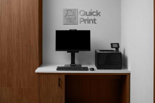 a computer sitting on top of a desk with a printer at Courtyard San Jose Airport in San Jose
