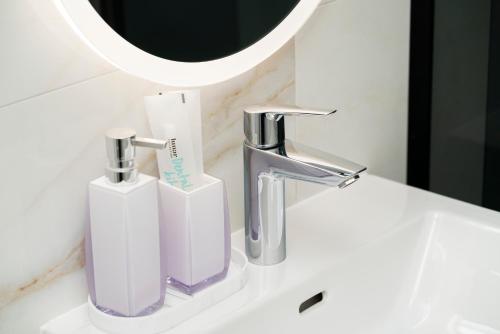 a bathroom sink with two toothbrushes and a mirror at Prestige Apartment Primošten in Primošten