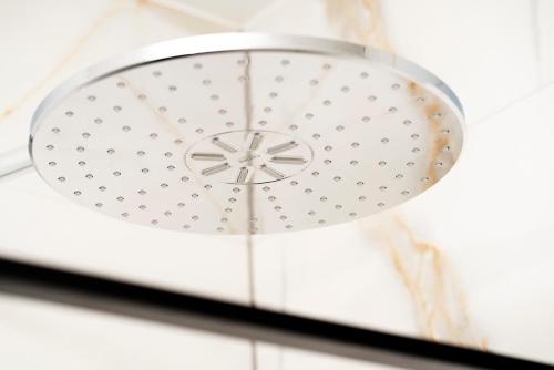 a ceiling light in a room with a white wall at Prestige Apartment Primošten in Primošten