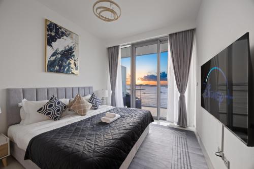 a bedroom with a large bed and a large window at YOUR STAY APARTMENTS Luxury Beachfront Living in Dubai