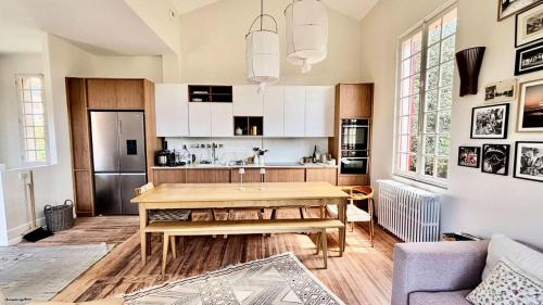 a kitchen with a wooden table in a room at Résidence 157-soulac Sur Mer - 157 - Maison de Charme de Style Basque avec Piscine Privée MAE-7391 in Soulac-sur-Mer