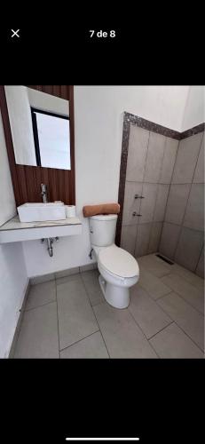 a bathroom with a toilet and a sink at Casa orquídea in San Luis de la Paz