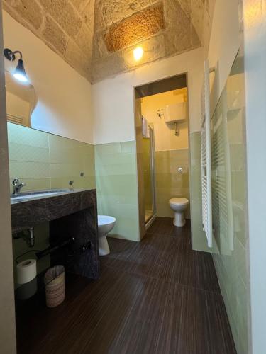 a bathroom with a sink and a toilet at Dimora 69 in Lecce