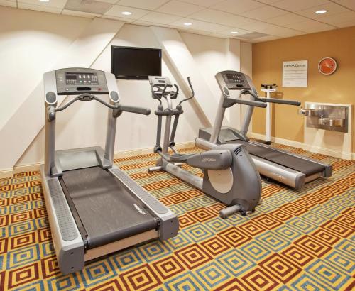 a gym with two treadmills and two exercise bikes at Holiday Inn Express Hotel & Suites Santa Cruz by IHG in Santa Cruz