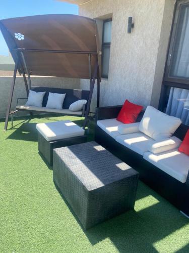 a room with two couches and a bed at Lovely penthouse 4- bedroom directly on the lagoon in El Alamein
