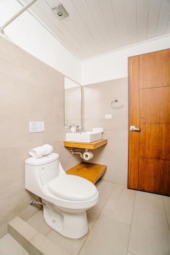 a bathroom with a toilet and a sink at Ocotal Beach House in Sardinal