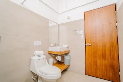 a bathroom with a toilet and a sink at Ocotal Beach House in Sardinal