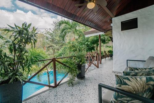 a balcony with a view of a pool at Ocotal Beach House in Sardinal