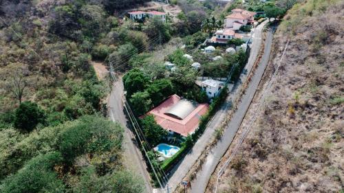 an aerial view of a house with a train at Ocotal Beach House in Sardinal
